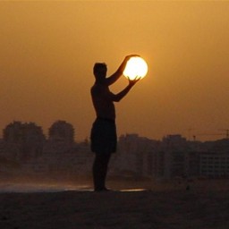 image of man holding sun